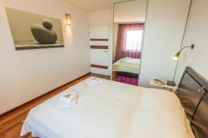 a hospital room with a bed and a mirror at Apartments Villa Dinka in Opatija