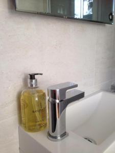 a soap dispenser sitting on a bathroom sink at The Studio in Newmarket