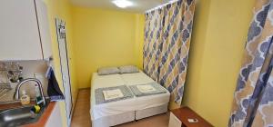a small bed in a small room with a sink at Rainbow 2 studio 7 in Sunny Beach +29 photos