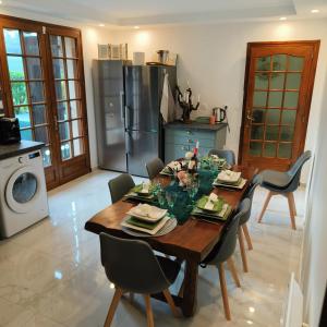 a kitchen with a wooden table with chairs around it at Magnifique villa au cœur de la nature in Marigny-en-Orxois +27 photos