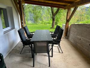 a table and chairs sitting on a patio at Apartments Barbra - Robinson life in Slovenj Gradec
