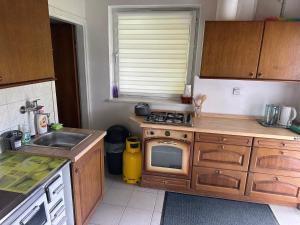 a small kitchen with a sink and a microwave at Apartments Barbra - Robinson life in Slovenj Gradec +13 photos
