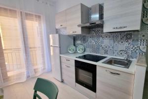 a kitchen with a sink and a stove top oven at Alice Apartment in Tropea +16 photos