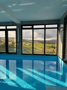 a house with a swimming pool with windows at Aqua Verde Sarajevo in Nišići