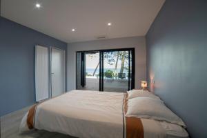 a bedroom with a large bed with a large window at Villa-SONNIER-Biscarrosse in Biscarrosse +21 photos