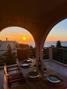 a table on a balcony with a view of the ocean at Unick Seaview Luxury Living in Kalathas