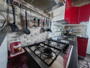 a kitchen with a stove top oven in a kitchen at Casa Vacanze il Mandarino in Santa Maria Del Focallo +6 photos