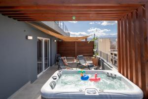 a hot tub on the balcony of a house at Anele Luxury Suites - Roof Top Jacuzzi in Chania