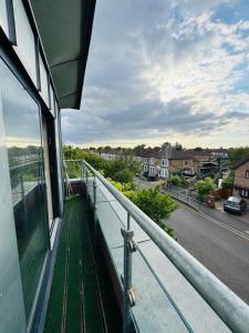 a balcony of a building with a view of a street at Charming 2 Bedroom Flat with Urban Views in Romford