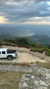 a white truck parked on top of a hill at Tiny House in the Mountains in San Cristóbal