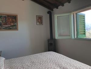 Postel nebo postele na pokoji v ubytování Camera al Poggio ai Grilli