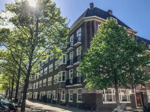 a large brick building with a tree in front of it at Authentic Amsterdam Apartment RAI in Amsterdam