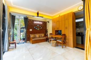 a living room with a couch and a table at Riverside Retreat in Kalyānpur