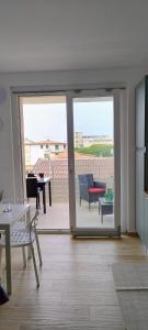 a living room with a sliding glass door to a patio at Terrazza mare e monti in Alba Adriatica
