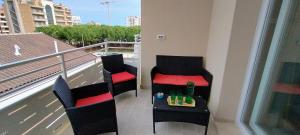 a balcony with two chairs and a table with drinks on it at Terrazza mare e monti in Alba Adriatica