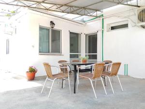 a table and chairs sitting on a patio at Old Cafe Apartment in Skala Kallirachis