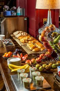 a buffet with many different types of bread and vegetables at Salisbury Arms Hotel in Hertford