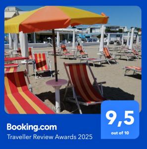 a group of lawn chairs and an umbrella on the beach at Il MARE alla FINESTRA in Cavallino-Treporti +74 photos