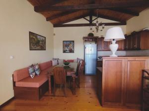 a kitchen and dining room with a table and a couch at Το Αρχοντικό του Κάστρου in Kyparissia
