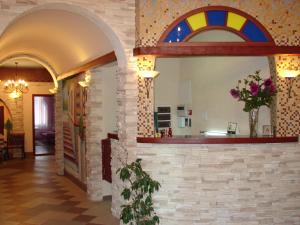 a hallway with a wall with a stained glass window at Family Hotel in Kurgan