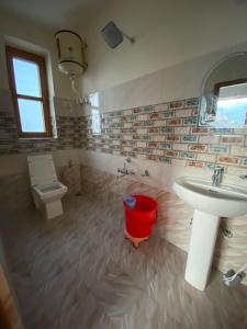 a bathroom with a sink and a toilet at The Mount View Retreat in Nako