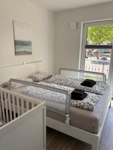 two bunk beds in a room with a balcony at V Gartenpalais Wohnung 1 in Norderney