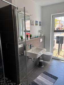 a bathroom with a sink and a toilet at V Gartenpalais Wohnung 1 in Norderney