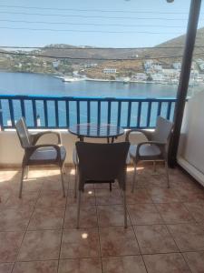 a balcony with a table and chairs and a view of the water at Ioannas rooms A6 in Mérikhas