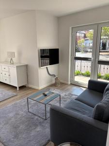 a living room with a couch and a coffee table at V Gartenpalais Wohnung 1 in Norderney +11 photos