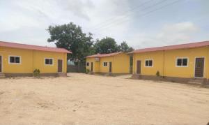 une rangée de maisons jaunes dans un village dans l'établissement SPR Sri Prathapa Rudra Cottages, à Manānūr