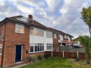 a house with solar panels on the roof at Livo Executive Suite near Bexleyheath Train in Bexleyheath