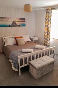 ein Schlafzimmer mit einem großen Bett mit weißem Rahmen in der Unterkunft Family house near the beach! in Saint Columb Minor