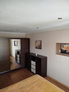 a bedroom with a bed and a large mirror at FourSpace in Ventspils