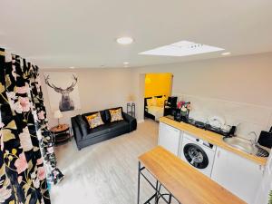 a kitchen and living room with a couch and a table at Livo Executive Suite near Bexleyheath Train in Bexleyheath