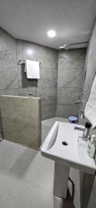 ein Badezimmer mit einem weißen Waschbecken und einer Badewanne in der Unterkunft Infinity Homestays 2 in Udaipur