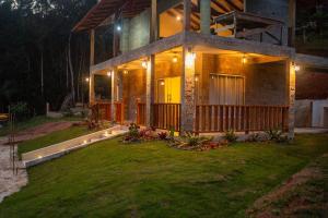 a large house with lights on the front of it at Chalés Montana in Domingos Martins