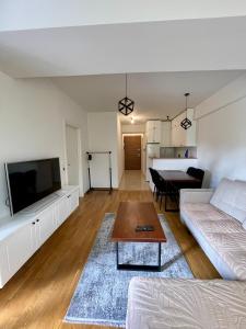 a living room with a couch and a table at The Home Away From Home 3 in Skopje