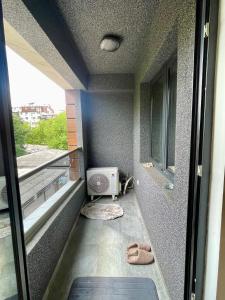 a small room with a balcony with a window at The Home Away From Home 3 in Skopje +21 photos