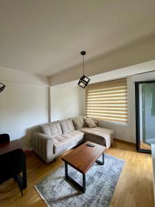 a living room with a couch and a coffee table at The Home Away From Home 3 in Skopje