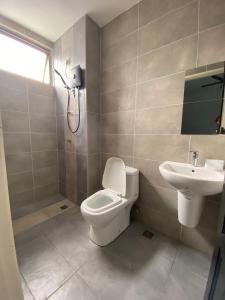 a bathroom with a toilet and a sink at WeStay Homestay 15-1 in Bukit Mertajam
