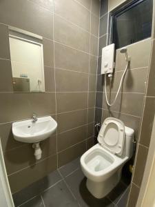 a bathroom with a toilet and a sink at WeStay Homestay 15-1 in Bukit Mertajam