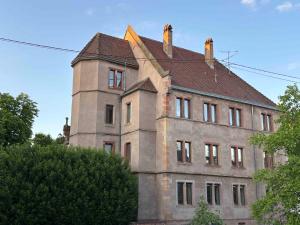 an old building with a turret on top of it at Une Place A Part in Obernai