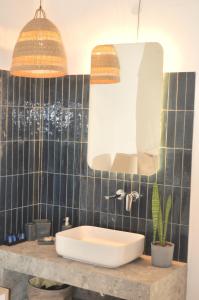 a bathroom with a sink and a mirror at Sea Side Studios & Houses in Kalo Livadi +37 photos