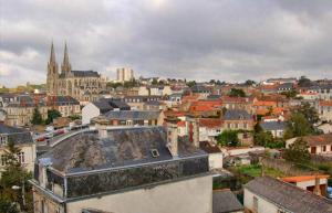a view of a city with buildings and roofs at L'Adresse tranquille Douceur et Discrétion in Cholet