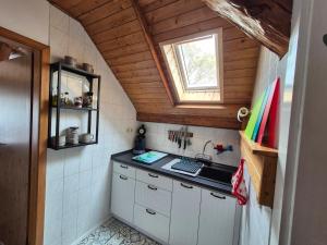 a small kitchen with a sink and a window at Ferienwohnung am See in Königs Wusterhausen