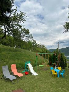 a playground with colorful chairs and a slide at Weekend getaway house in Goražde