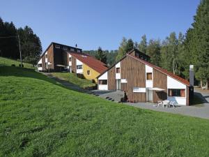 a group of barns on a grassy hill at Ferienhaus mit herrlicher Aussicht in Schmallenberg