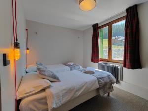 a bedroom with two beds and a window at Petit Mont Blanc Guest House in Peisey-Nancroix