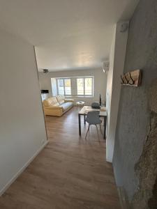 a living room with a couch and a table at Appartement entier proche château de Miniac-Morvan in Miniac-Morvan +1 photo