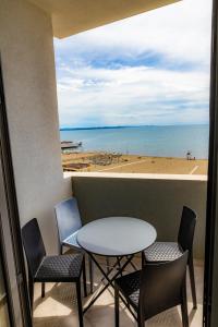 a table and chairs with a view of the beach at Eden Hotel in Shëngjin